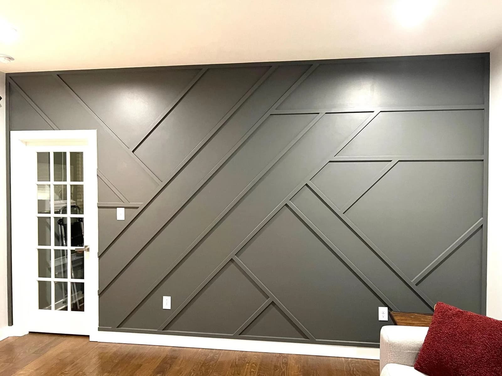 Graphite geometric accent wall in a finished living room