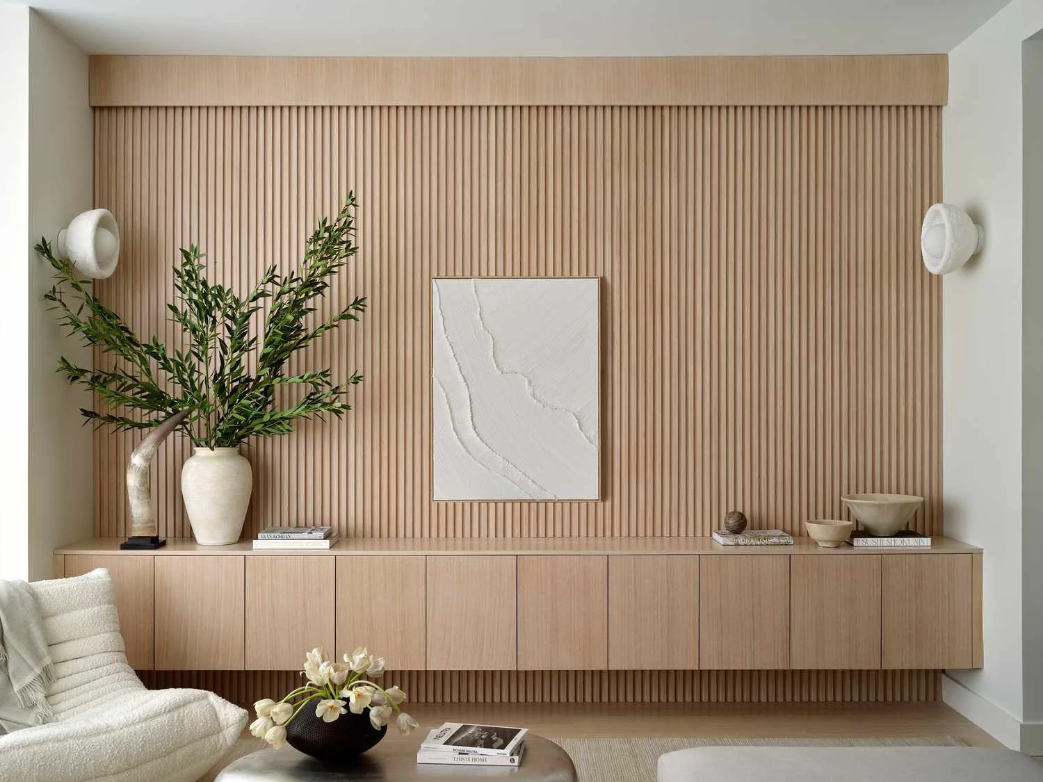Light oak slat wall with integrated floating cabinetry